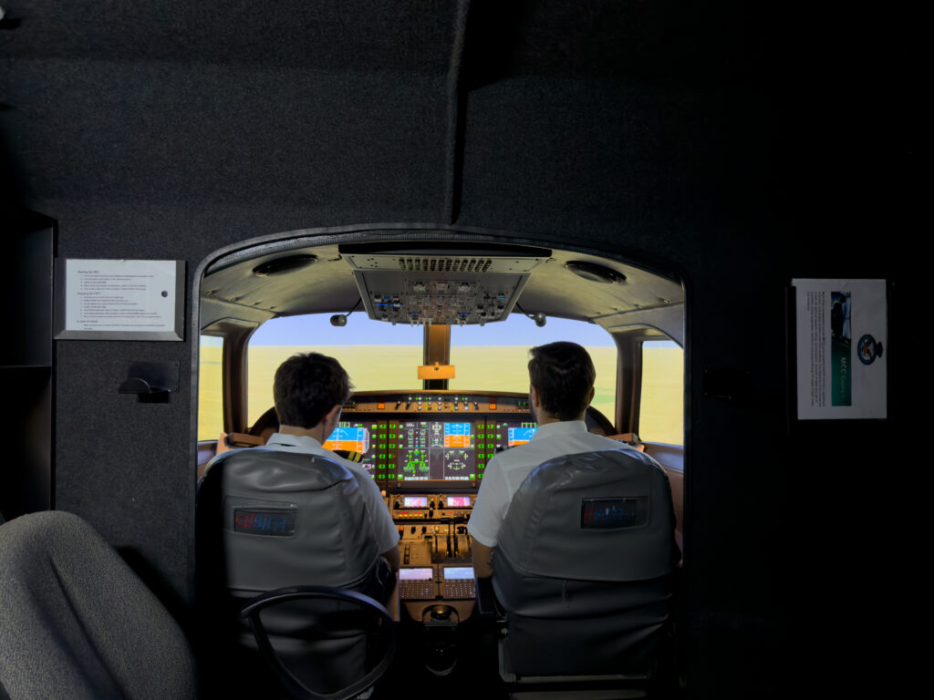 Pilot operating aircraft cockpit controls